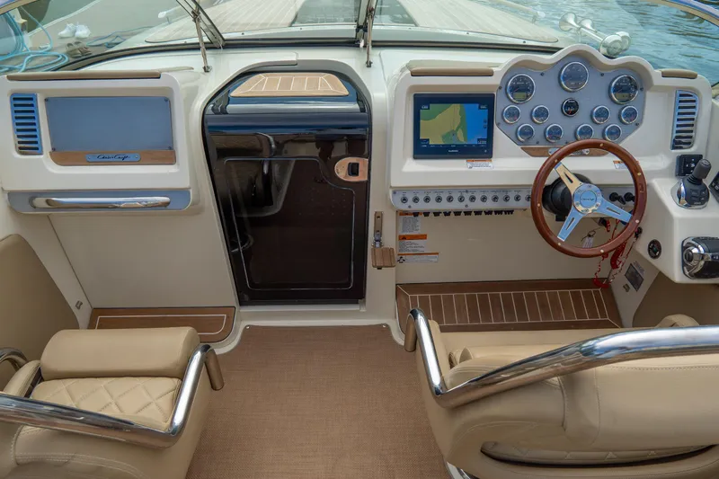 Slide: The Image of 2017 Chris-Craft Corsair 28 Heritage Edition cockpit with classic steering wheel and navigation display. - 30
