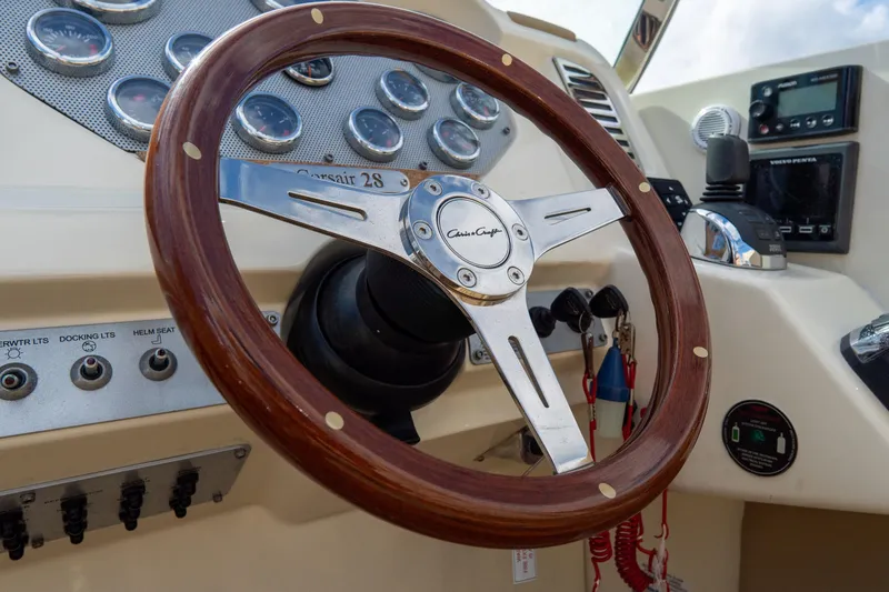 Slide: The Image of Steering wheel of 2017 Chris-Craft Corsair 28 Heritage Edition boat dashboard. - 33