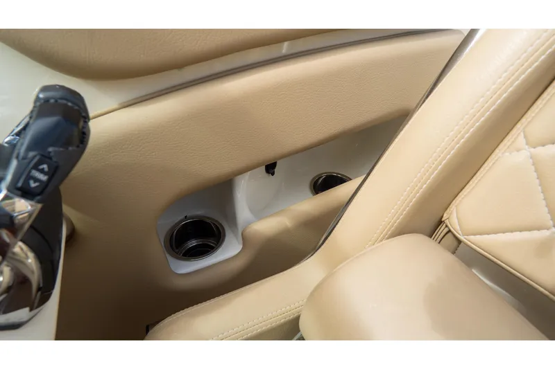 Slide: The Image of 2017 Chris-Craft Corsair 28 Heritage Edition interior with beige leather and cup holders. - 37