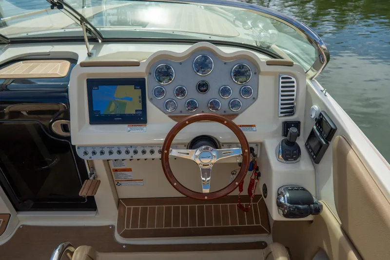 Slide: The Image of 2017 Chris-Craft Corsair 28 Heritage Edition dashboard with navigation system and wooden steering wheel. - 40