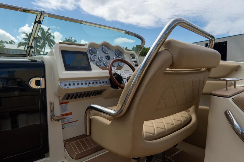Slide: The Image of 2017 Chris-Craft Corsair 28 Heritage Edition cockpit with luxurious leather seating and modern controls. - 43