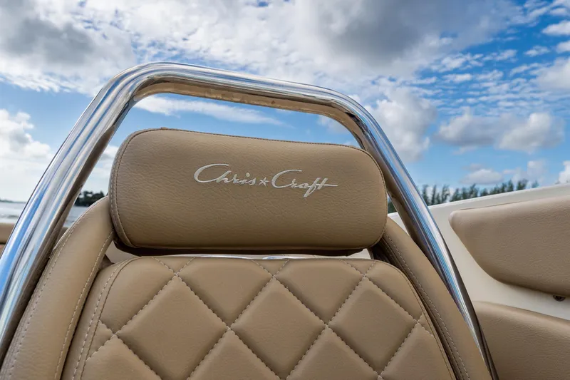 Slide: The Image of 2017 Chris-Craft Corsair 28 Heritage Edition seat with logo, under a blue sky. - 47