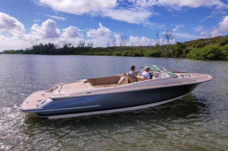 Slide: The Image of 2017 Chris-Craft Corsair 28 Heritage Edition boat cruising on a serene lake. - 51