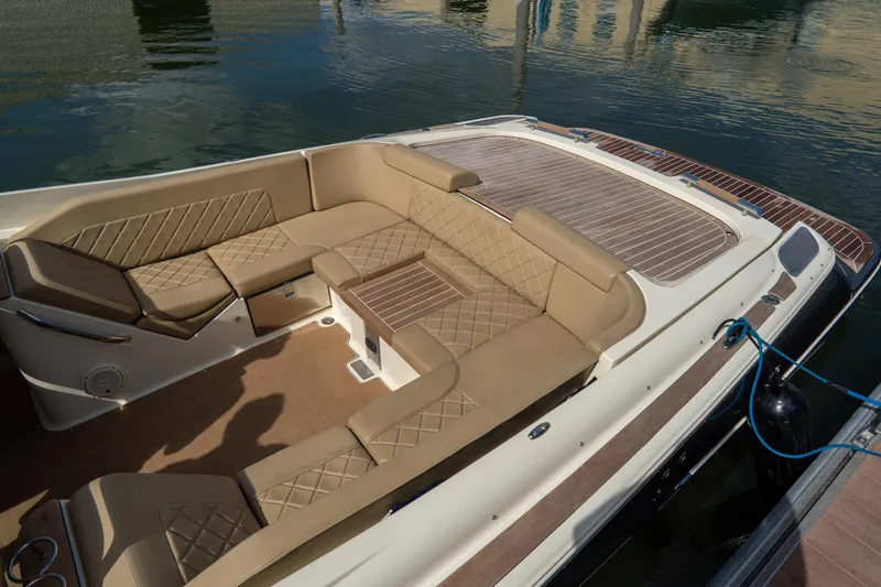 Slide: The Image of Luxurious seating on 2017 Chris-Craft Corsair 28 Heritage Edition boat, docked by the water. - 54