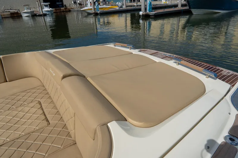 Slide: The Image of 2017 Chris-Craft Corsair 28 Heritage Edition with tan leather seating, docked by the water. - 58