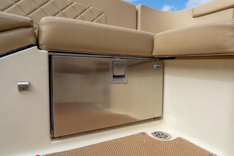 Slide: The Image of 2017 Chris-Craft Corsair 28 Heritage Edition interior with stainless steel storage and beige seating. - 64