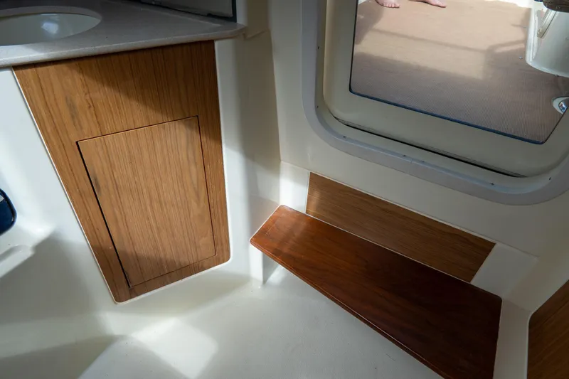 Slide: The Image of 2017 Chris-Craft Corsair 28 Heritage Edition interior with wooden cabinetry and seating. - 71