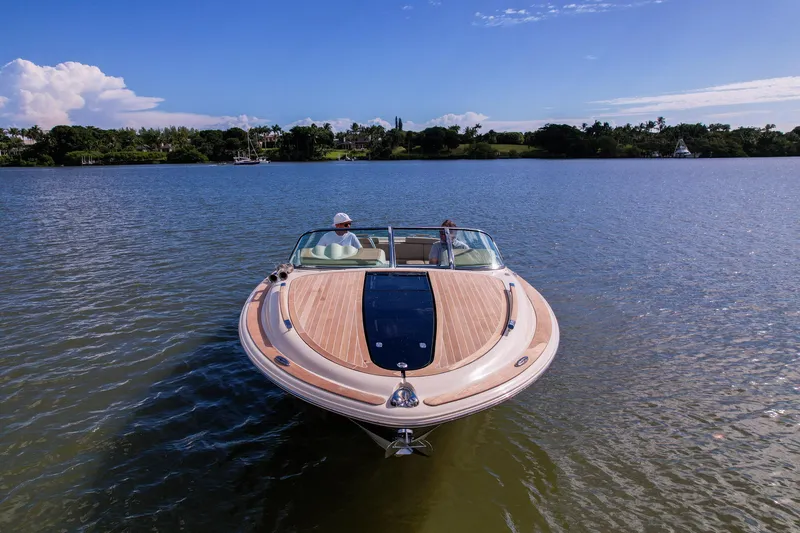 Slide: The Image of 2017 Chris-Craft Corsair 28 Heritage Edition on serene lake under clear blue sky. - 75