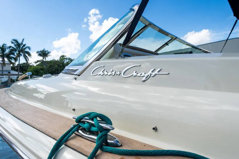 Slide: The Image of 2017 Chris-Craft Corsair 28 Heritage Edition boat with blue sky and palm trees. - 78
