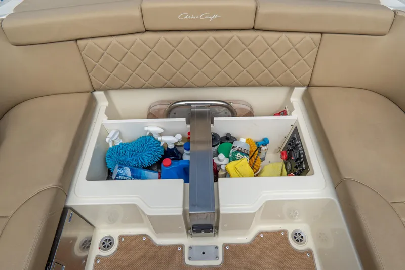 Slide: The Image of 2017 Chris-Craft Corsair 28 Heritage Edition boat storage compartment with cleaning supplies. - 84
