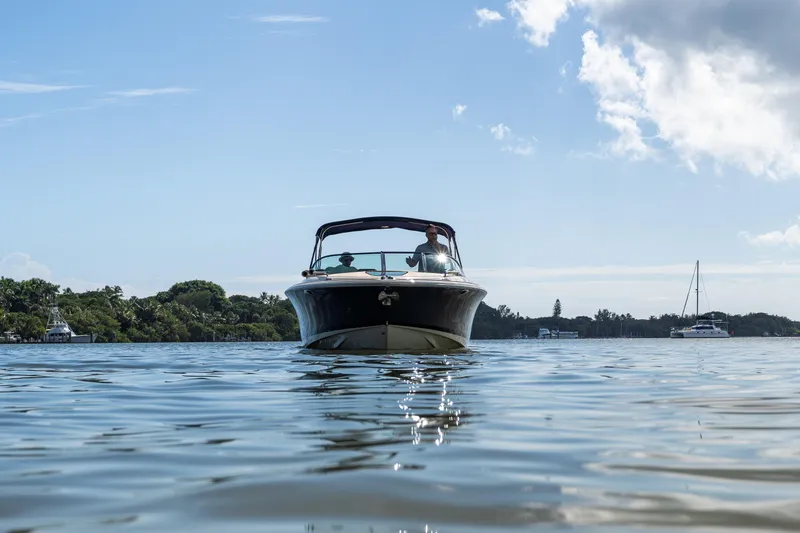 Slide: The Image of 2017 Chris-Craft Corsair 28 Heritage Edition cruising on calm waters under a clear sky. - 87