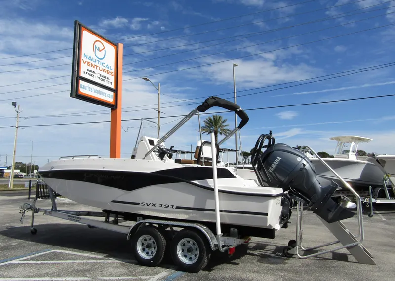 Slide: The Image of 2024 Starcraft SVX 191 OB CC boat on trailer at Nautical Ventures dealership. - 1
