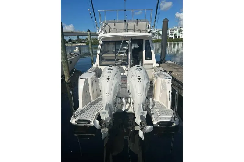 Slide: The Image of 2026 Solara S-310 SB boat with dual 300 HP engines docked at marina. - 12