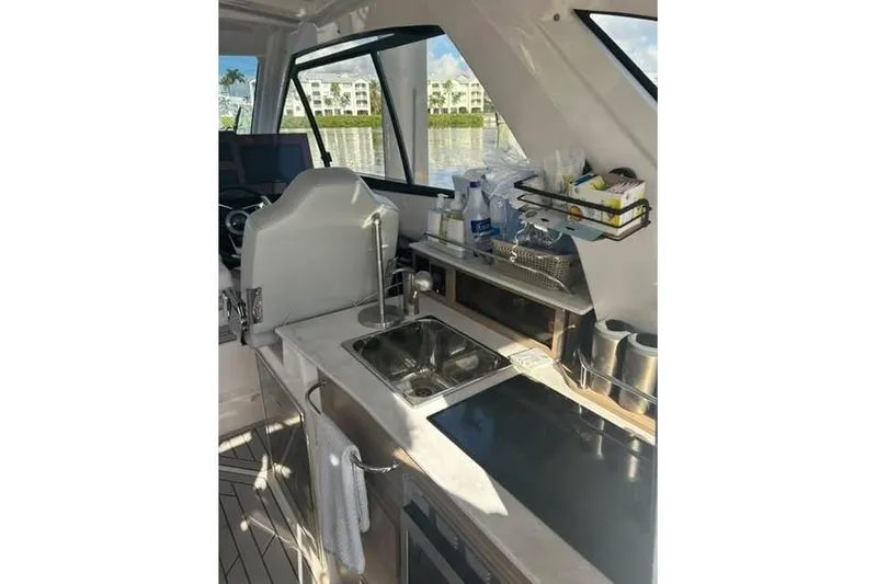 Slide: The Image of Interior of 2026 Solara S-310 SB boat featuring a compact kitchen area. - 16