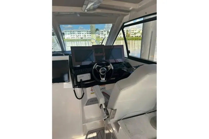 Slide: The Image of Interior of 2026 Solara S-310 SB boat with modern steering and navigation systems. - 6