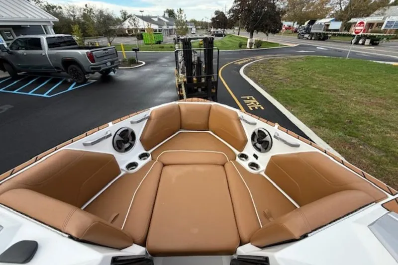 Slide: The Image of 2021 Malibu Wakesetter 22 LSV boat with tan seating and cup holders. - 10