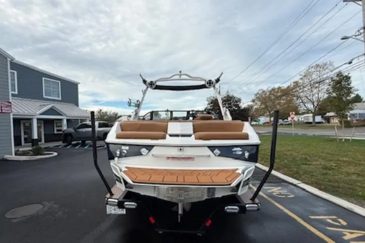 Slide: The Image of 2021 Malibu Wakesetter 22 LSV boat parked, rear view, in a parking lot. - 4