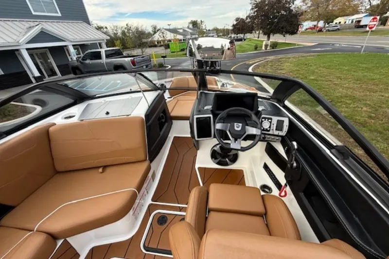 Slide: The Image of 2021 Malibu Wakesetter 22 LSV interior with tan seating and modern dashboard. - 6