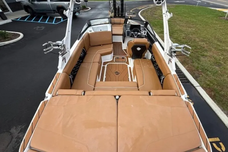 Slide: The Image of 2021 Malibu Wakesetter 22 LSV interior with tan seating and modern dashboard. - 8