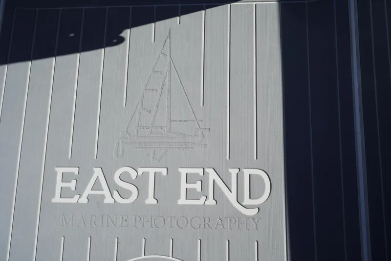 Slide: The Image of East End Marine Photography logo on Fish Hawk 230 CC, 2002 model boat deck. - 12