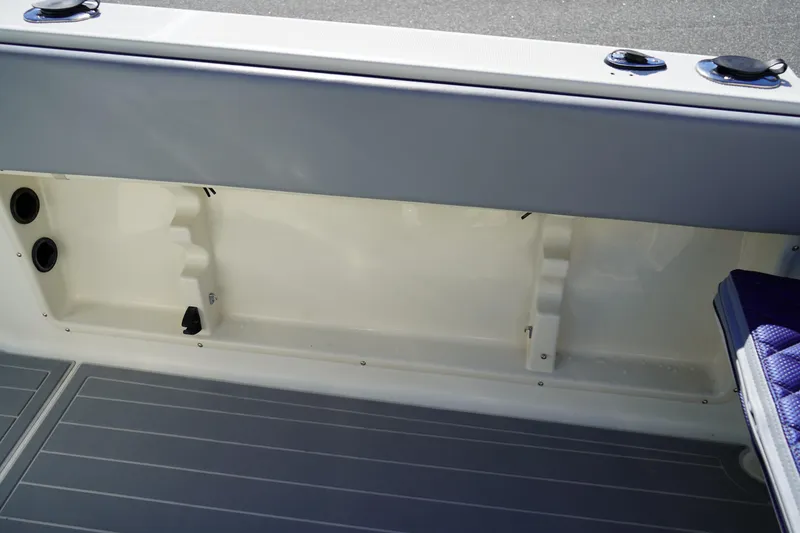 Slide: The Image of Fish Hawk 230 CC 2002 boat interior storage compartment with gray flooring. - 14