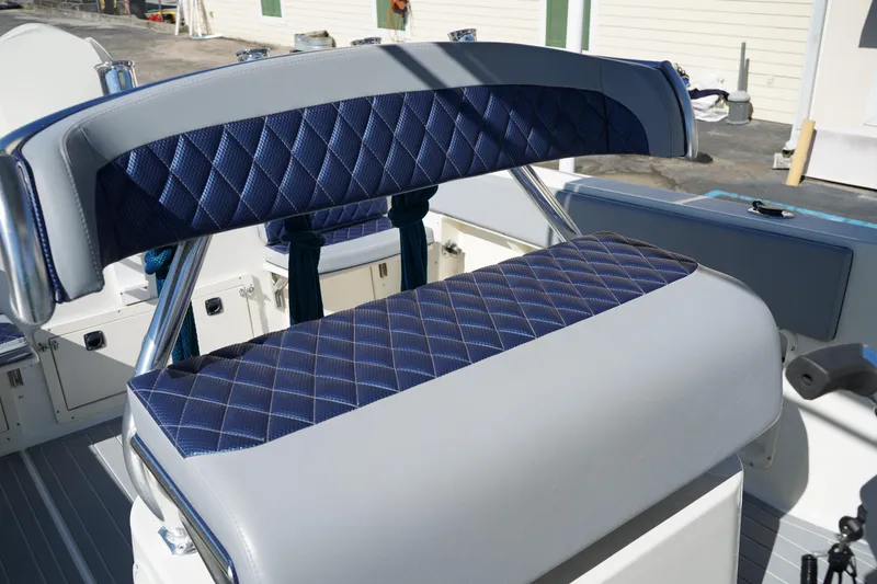 Slide: The Image of Blue and gray diamond-stitched seating on 2002 Fish Hawk 230 CC boat. - 16