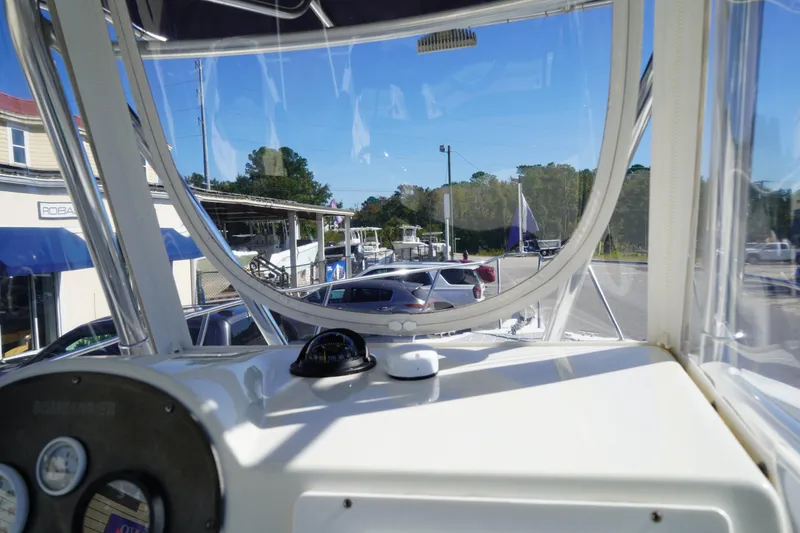 Slide: The Image of Interior view of a 2002 Fish Hawk 230 CC boat, showing dashboard and clear canopy. - 20