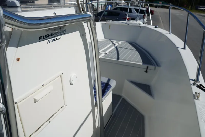 Slide: The Image of 2002 Fish Hawk 230 CC boat interior with seating and storage compartments. - 25