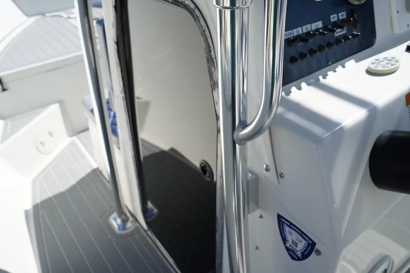 Slide: The Image of Interior view of 2002 Fish Hawk 230 CC boat, featuring control panel and stainless steel railing. - 26
