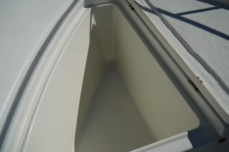 Slide: The Image of Storage compartment on a 2002 Fish Hawk 230 CC boat, featuring clean white interior. - 32