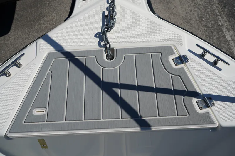 Slide: The Image of Bow deck of 2002 Fish Hawk 230 CC boat with anchor chain and cleats. - 34