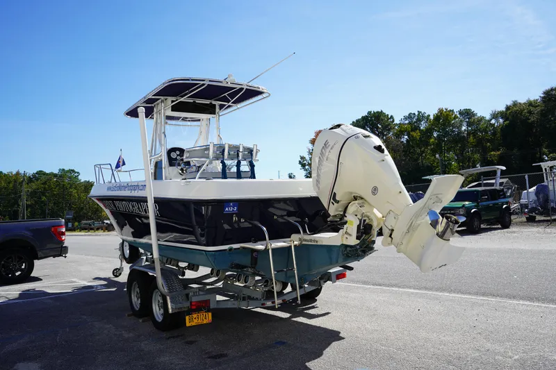 Slide: The Image of 2002 Fish Hawk 230 CC boat on trailer with outboard motor in parking lot. - 4