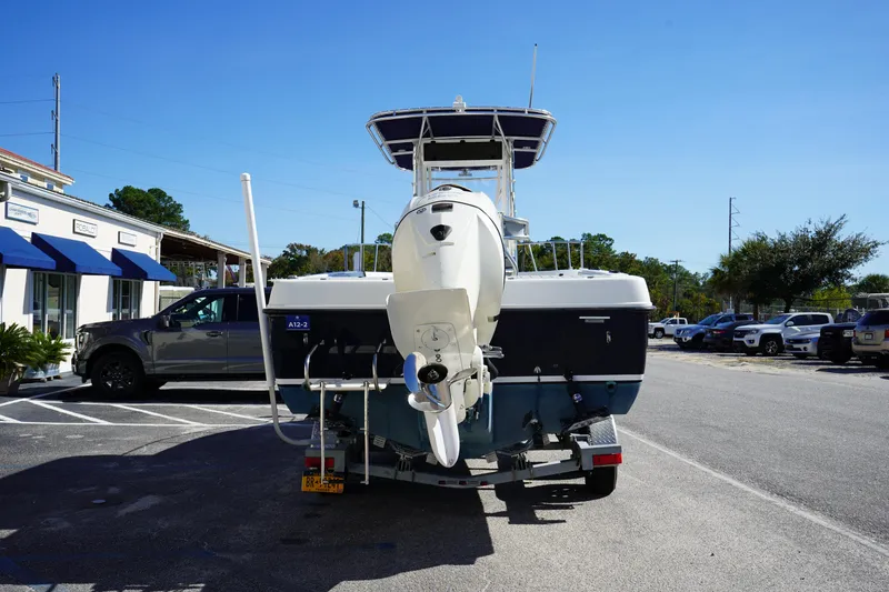 Slide: The Image of 2002 Fish Hawk 230 CC boat on trailer in parking lot, sunny day. - 5