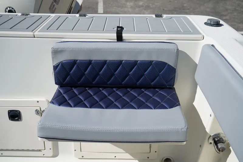 Slide: The Image of Blue and gray cushioned seat on 2002 Fish Hawk 230 CC boat. - 6