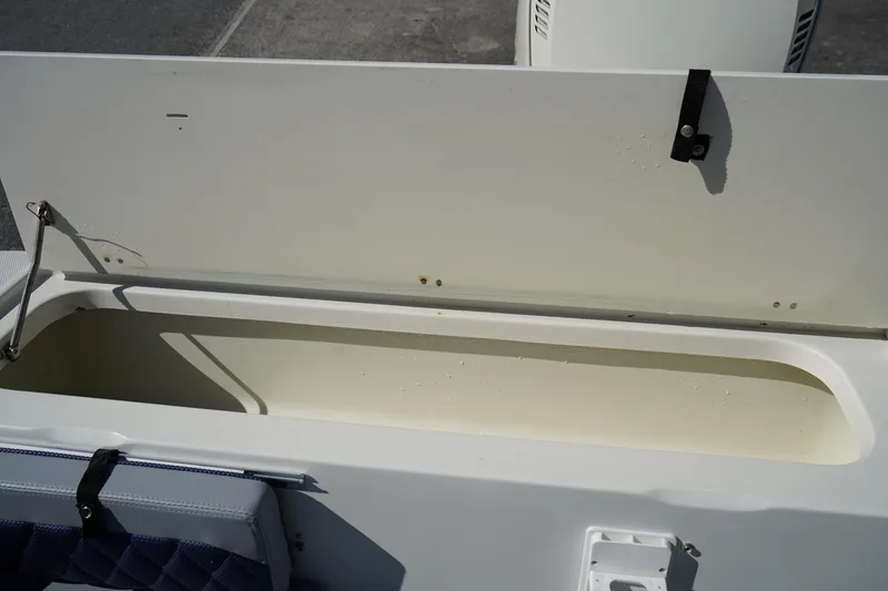 Slide: The Image of Open storage compartment on a 2002 Fish Hawk 230 CC boat. - 9