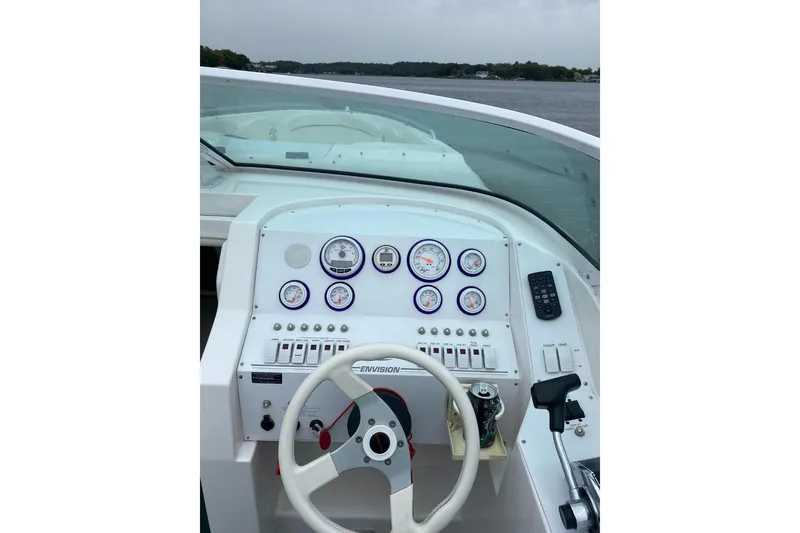 Slide: The Image of Cockpit view of 2004 Envision 2900 Combo boat with steering wheel and gauges. - 10