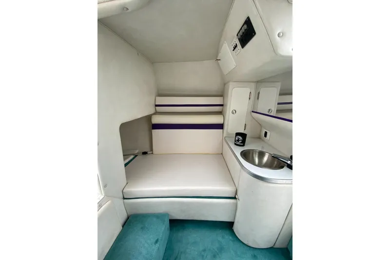Slide: The Image of 2004 Envision 2900 Combo boat interior with seating and sink area. - 12