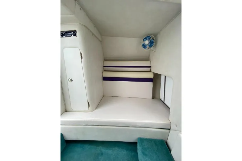 Slide: The Image of 2004 Envision 2900 Combo boat interior with cushioned seating and compact fan. - 13