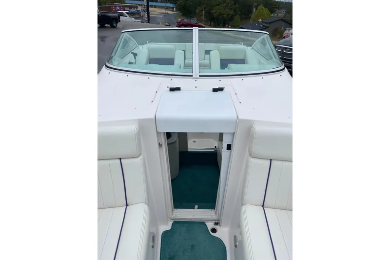 Slide: The Image of 2004 Envision 2900 Combo boat interior with white seating and teal carpet. - 15