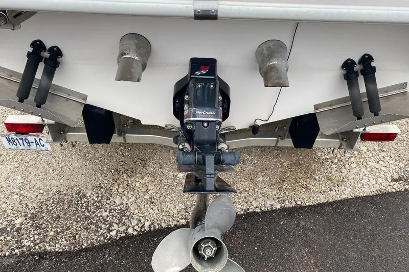 Slide: The Image of Rear view of a 2004 Envision 2900 Combo boat with MerCruiser outdrive. - 17