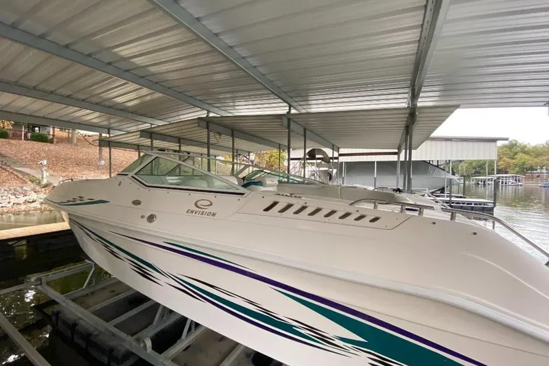 Slide: The Image of 2004 Envision 2900 Combo boat docked under a metal canopy. - 2