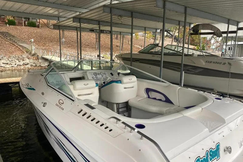 Slide: The Image of 2004 Envision 2900 Combo boat docked in a covered marina. - 3
