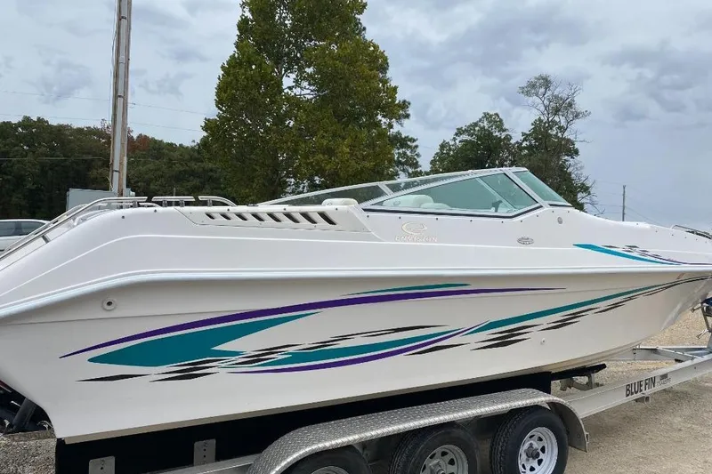 Slide: The Image of 2004 Envision 2900 Combo boat on trailer, featuring sleek design and vibrant graphics. - 5