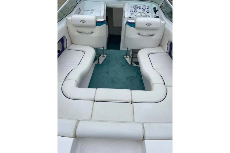 Slide: The Image of 2004 Envision 2900 Combo boat interior with white seating and teal carpet. - 6