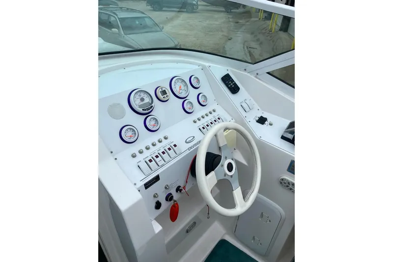 Slide: The Image of 2004 Envision 2900 Combo boat dashboard with gauges and steering wheel. - 9