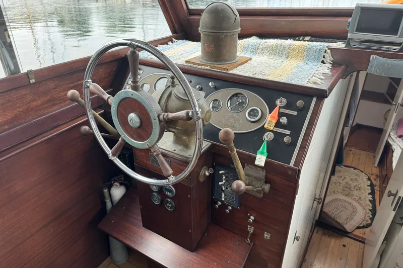 Slide: The Image of 1940 Elco Cruisette helm with vintage steering wheel and control panel. - 10
