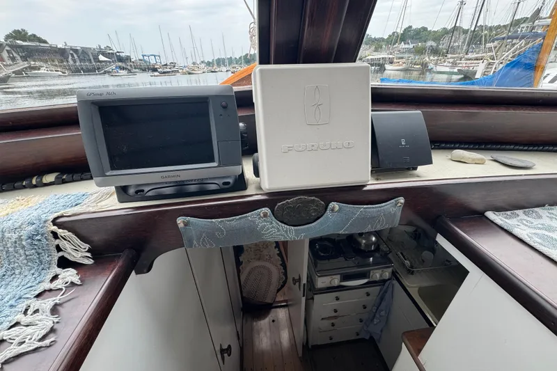 Slide: The Image of 1940 Elco Cruisette interior with navigation equipment and marina view. - 11