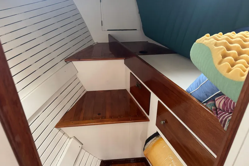 Slide: The Image of 1940 Elco Cruisette interior with wooden steps, storage, and cushions. - 15