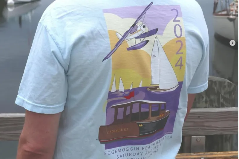 Slide: The Image of T-shirt featuring 2024 Eggemoggin Reach Regatta design with vintage Elco Cruisette boat illustration. - 19