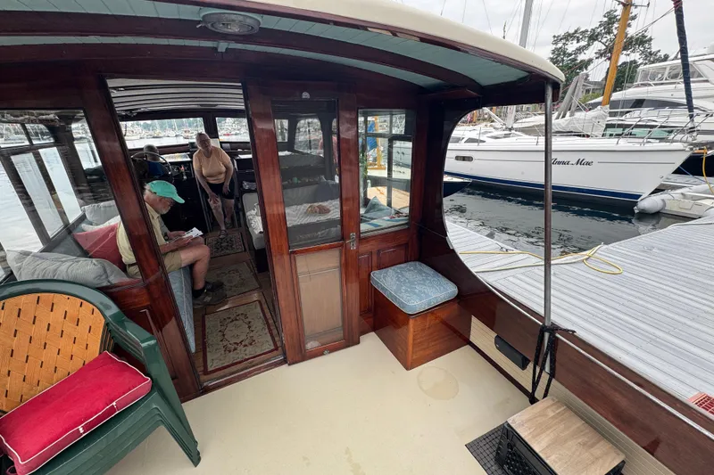 Slide: The Image of 1940 Elco Cruisette boat interior with wooden finish, docked at marina. - 4
